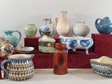 many different vases and bowls on display on a table
