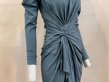 the mannequin is wearing a gray dress with a knot around the waist