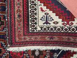 a close up of a rug with a red and blue design