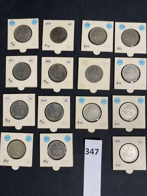 several different types of coins are displayed on a black surface