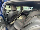the interior of a blue car with black seats and a red seat belt