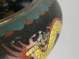 a close up of a vase with a dragon painted on it