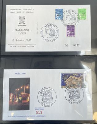 two envelopes with stamps on them are sitting on a table