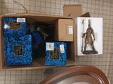 a box of books and a clock sitting on a table