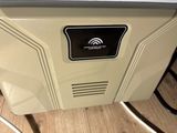 an image of a white and black microwave on a wooden floor