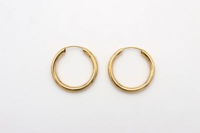 a pair of gold hoop earrings on a white background