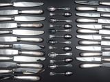 a lot of knives that are sitting on a table