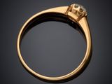 a close up of a gold ring with a diamond on it