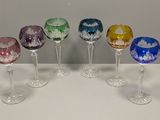 six wine glasses are lined up in a row on a table