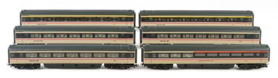 several model trains are stacked on top of each other on a white surface