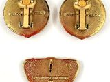two pairs of gold tone cufflinks with the letter t on them