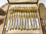 a lot of silverware in a case on a table