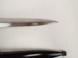 two knives that are laying next to each other on a table