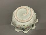 a small white bowl with a flower design on it