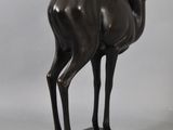 statue of a ram standing on a base with a white background