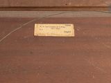 a label on a piece of wood that is on the floor