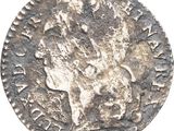a silver coin with a head of a man on it