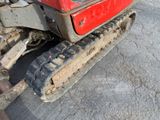 a red tractor that is parked on the side of the road