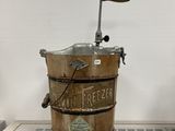a wooden bucket with a handle on top of a table