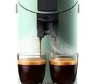 two cups of coffee being poured into a coffee machine
