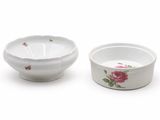 two white bowls with pink flowers on them on a white surface