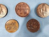 four different types of coins are shown on a blue surface