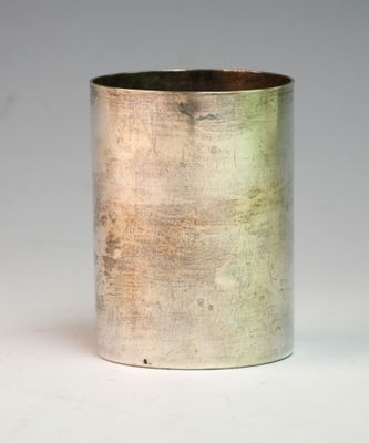 a silver cup that is sitting on a table