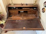 an old wooden desk with a drawer underneath it