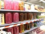 many jars of liquid on the shelves in the store