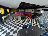 a checkered floor in a restaurant with tables and chairs