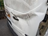 a picture of a dirty van parked on the side of the road