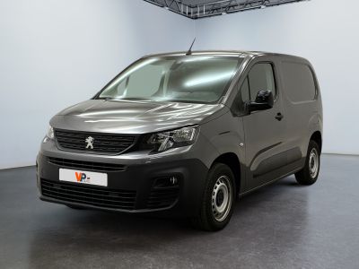 the grey van is parked in the large room of the building