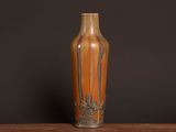 a vase that is sitting on a table with a black background