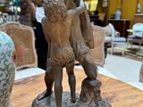 a bronze statue of a man and a woman on a table