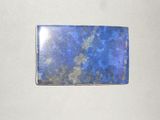 a close up of a piece of blue stone on a white surface