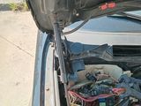 a car with its hood open and the engine in the trunk