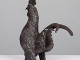 bronze sculpture of a rooster standing on its hind legs