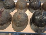 several helmets are sitting on a table in a warehouse