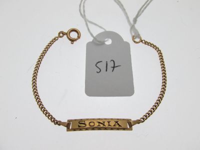 a close up of a gold bracelet with a price tag on it