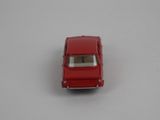 a red toy car sitting on a white surface