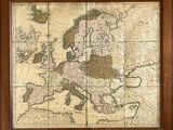 an old map of europe in a wooden frame on a wall