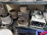 many pots and pans on a shelf in a kitchen