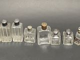 a lot of glass bottles that are sitting on a table