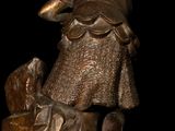 a bronze statue of a man with a dog on a rock