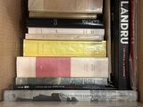 a box full of books that are stacked on top of each other