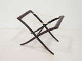 a black and white photo of a wooden folding chair