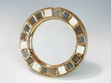a gold plate with a mirror in the middle of it