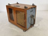 a small wooden box with a metal handle on it