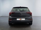 the rear of a black volkswagen v - cross parked in a white room