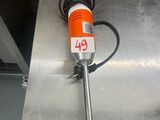 an orange and white electric hand held device on a metal surface